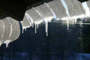 Snow Curls Off the Barn